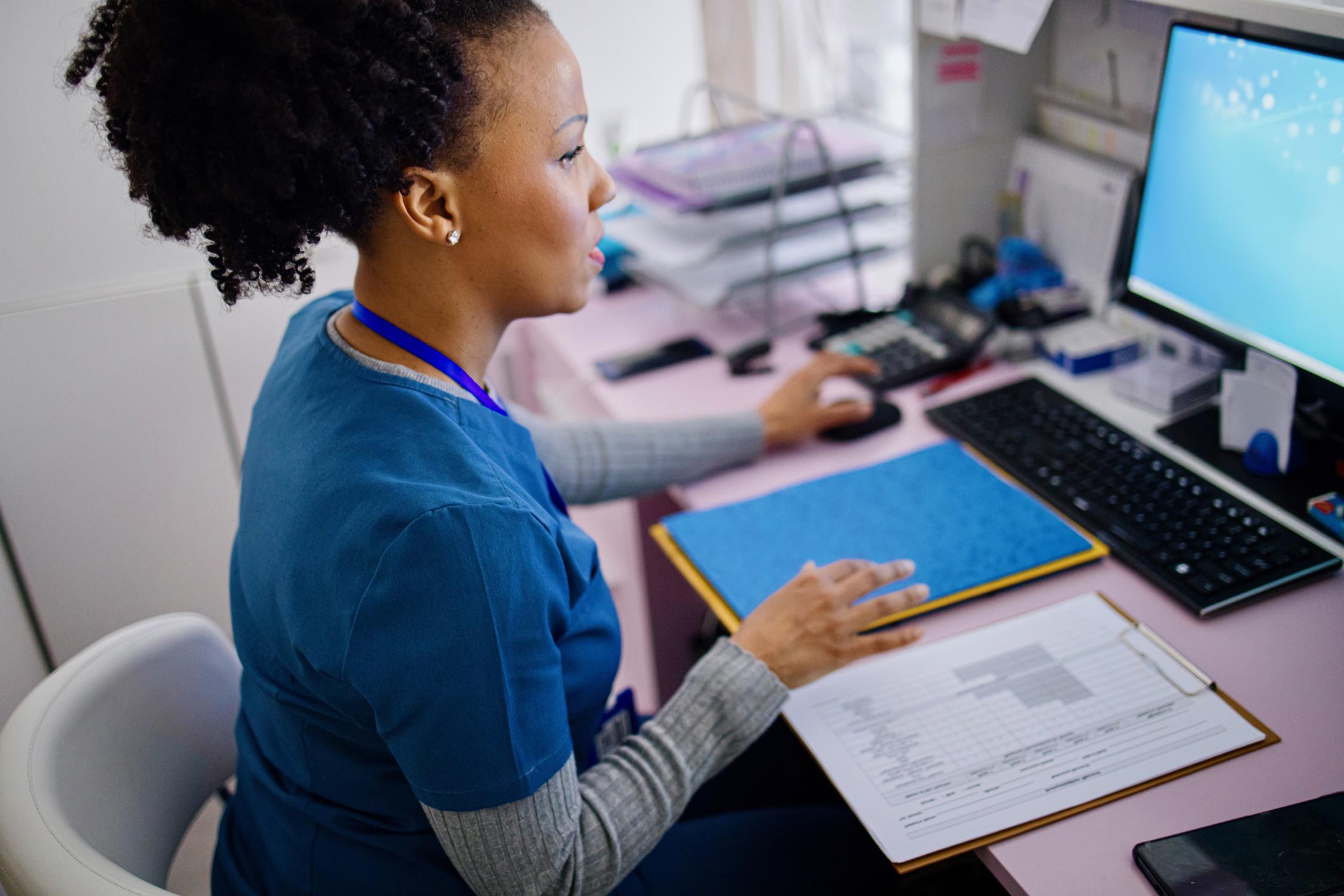 nurse studying at a computer