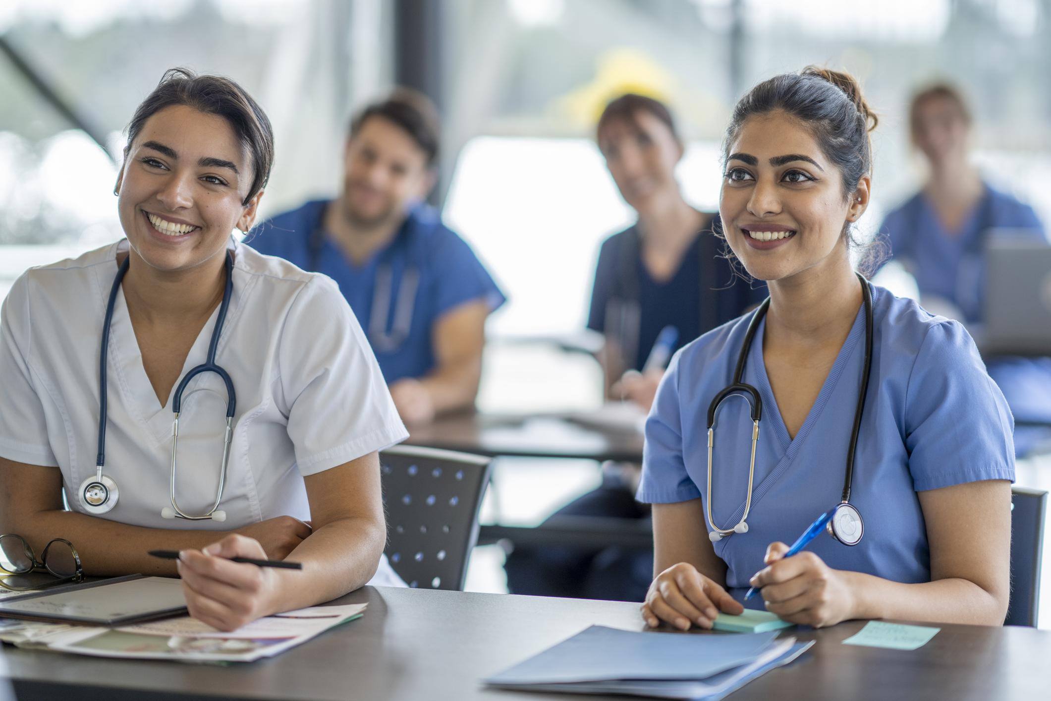 nurse sitting and listening to speaker